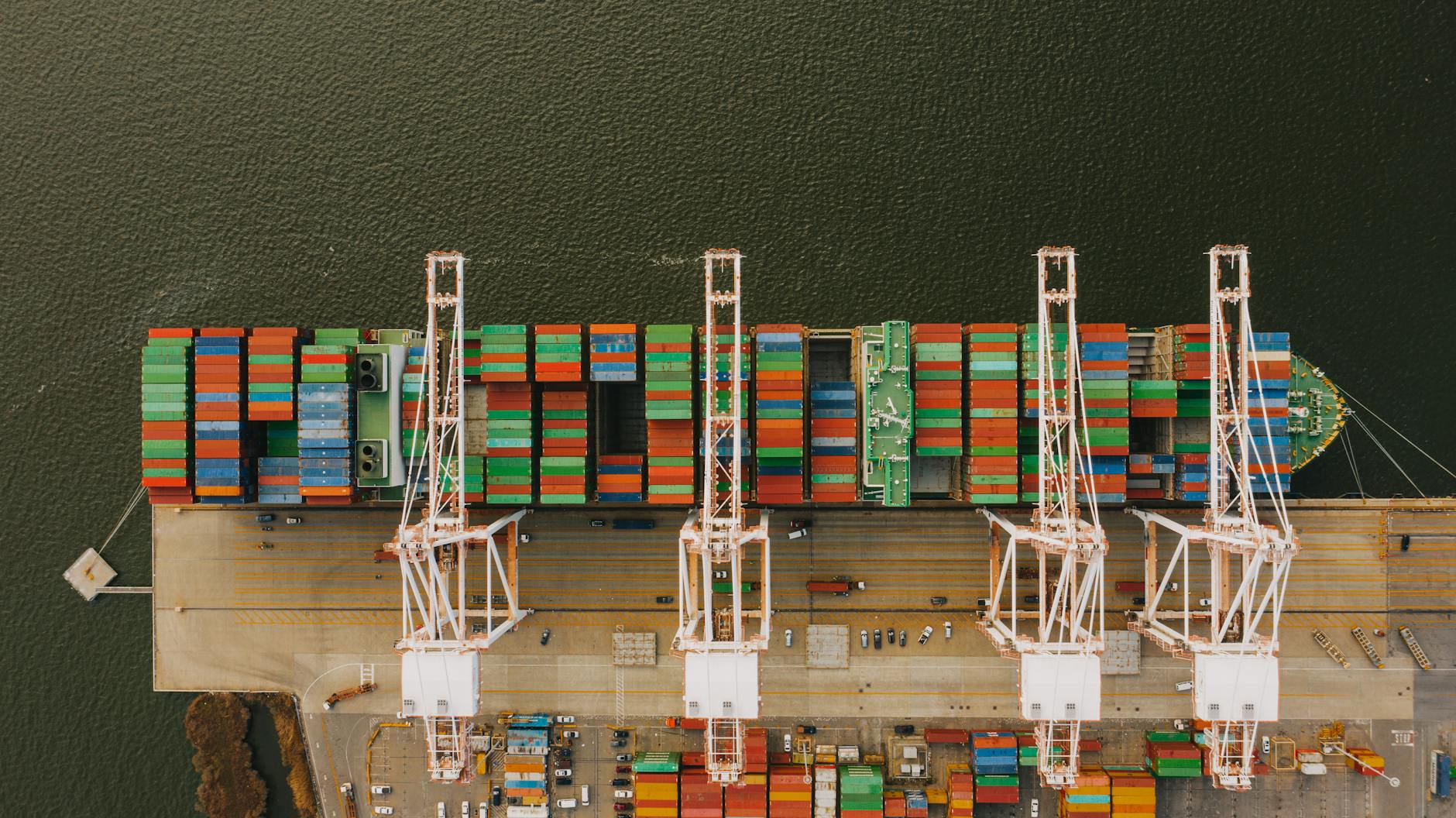 Overhead shot of colorful cargo containers and cranes at Baltimore's bustling port.